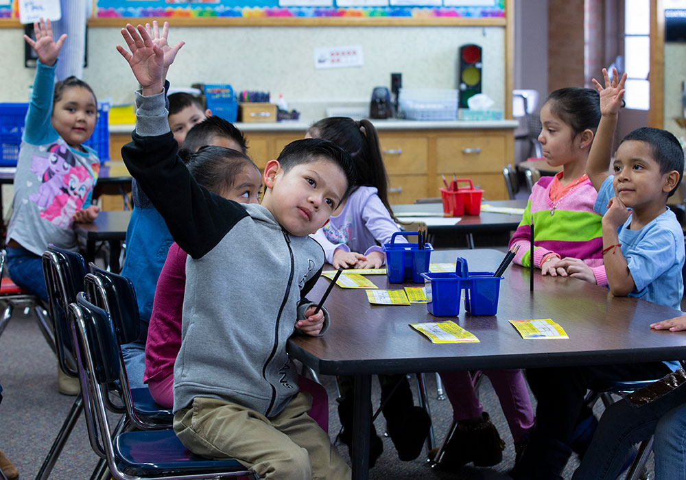 Kids raising hands