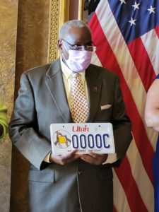 Dr. Crawford holding the Black History license plate