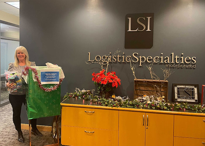 LSI employee stands with socks near the donation bin