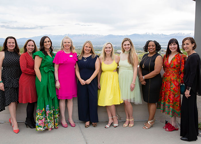 Women United members in colorful dresses at Power of Your Purse