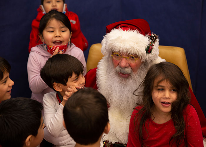 Students at Moss Elementary pose with Santa Claus