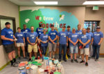Williams volunteers in front of the mural they painted at Day of Caring