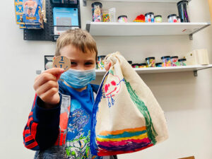 Student poses with gifts from Friends of the Children