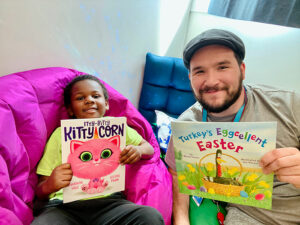 Mentor and mentee pose with books