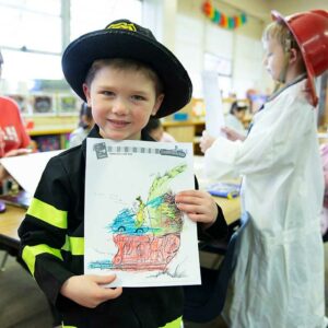 Kindergartner holding drawing