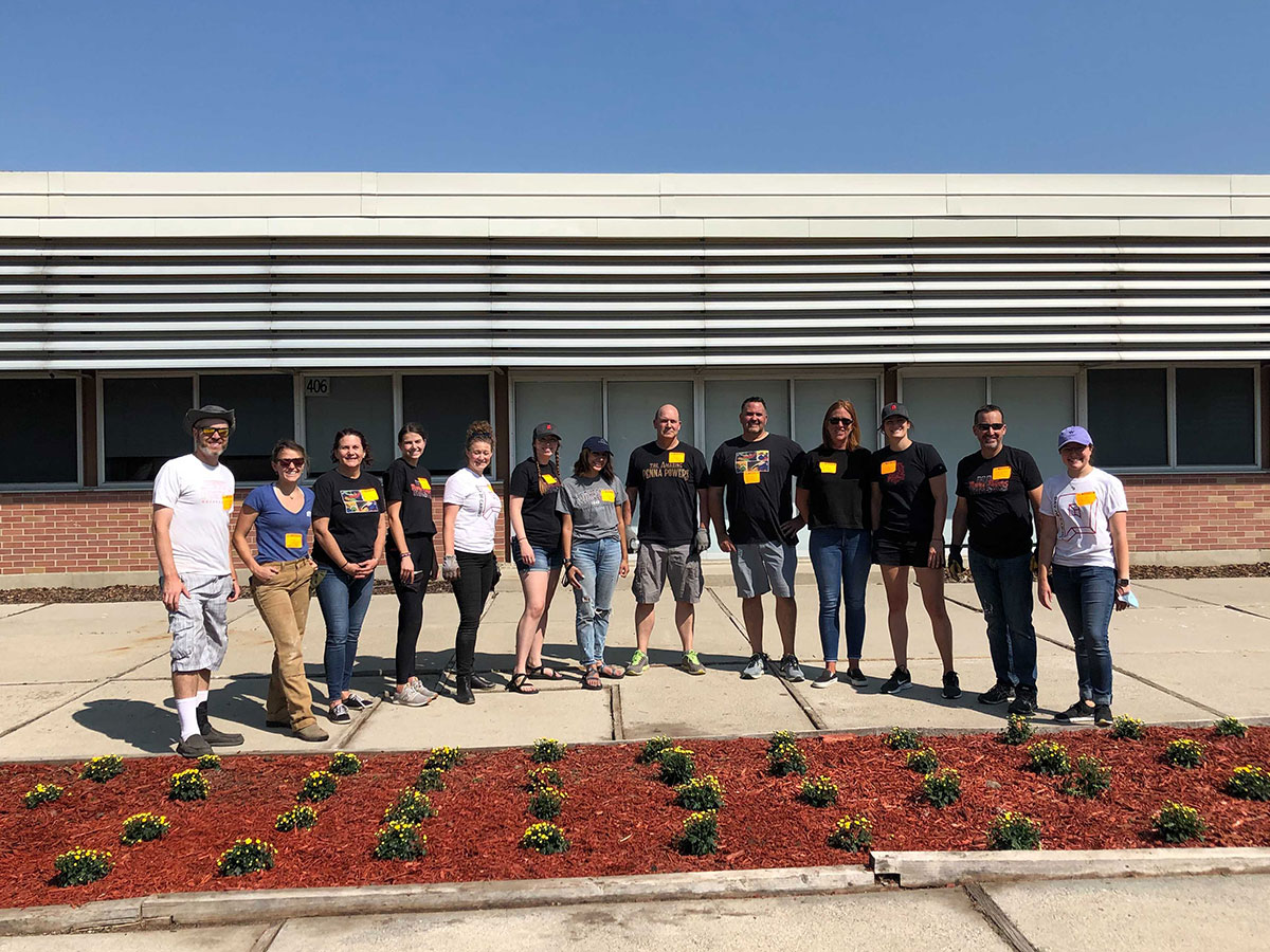 Penna Powers volunteers stand by completed garden