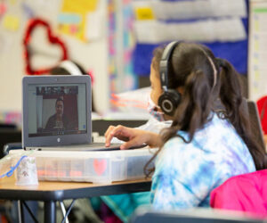 Girl in classroom with virtual tutor