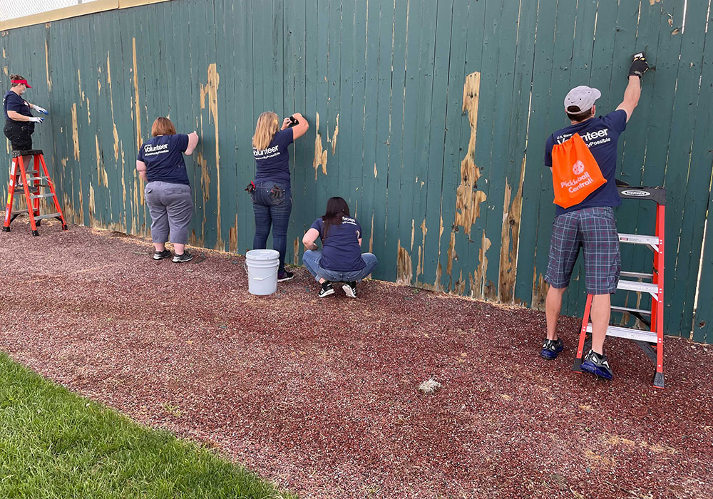 US Bank painting fence at Day of Caring