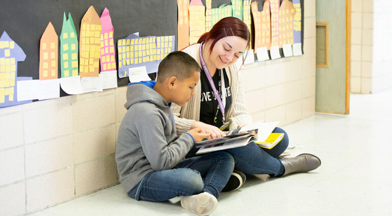 Volunteer reading with student