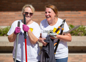 Volunteers with garden tools laughing